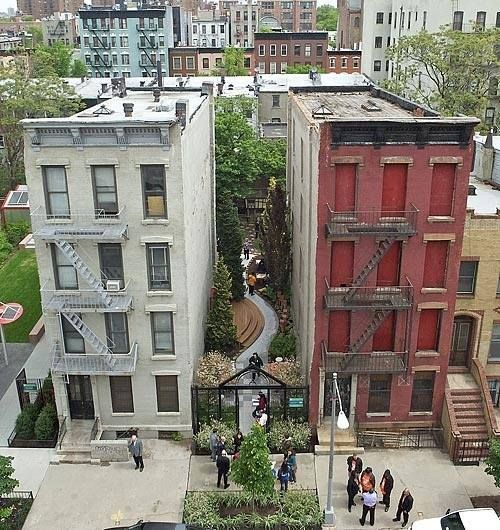 an aerial view of several buildings and people walking on the sidewalk in front of them