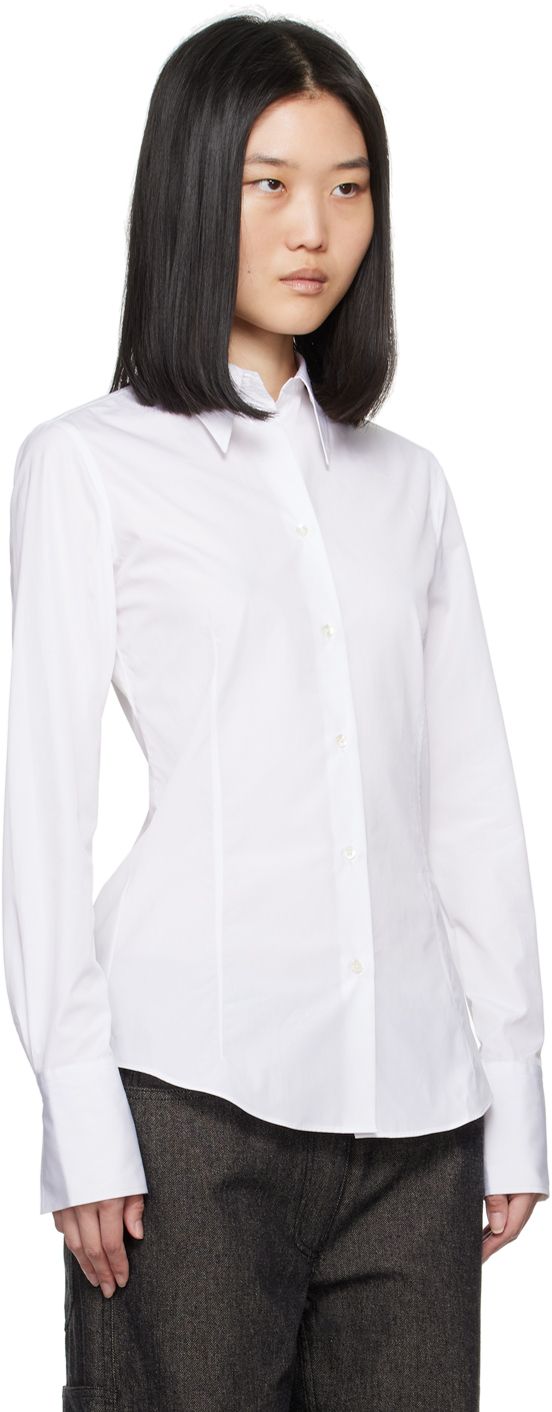 Heavyweight slim-fit organic cotton poplin shirt. · Spread collar · Button closure · Darts at front and back · Shirttail hem · Single-button barrel cuffs · Mother-of-pearl hardware Supplier color: White Elegant Cotton Shirt With Shirttail Hem, Timeless Slim Fit Tops For Office, Timeless Slim Fit Office Tops, Workwear Dress Shirt With Spread Collar And Covered Buttons, Fitted Business Blouse With Placket, Fitted Blouse With Placket For Business, Cotton Blouse With Fold Down Collar, Classic Fitted Blouse With Hidden Button Closure, Timeless Fitted Cotton Blouse