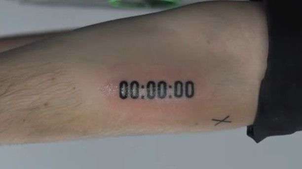 a person with a tattoo on their arm that says co - 00, 0000