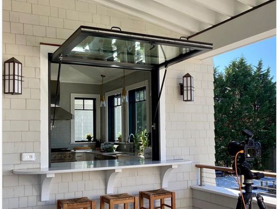 an outdoor bar with two stools on it