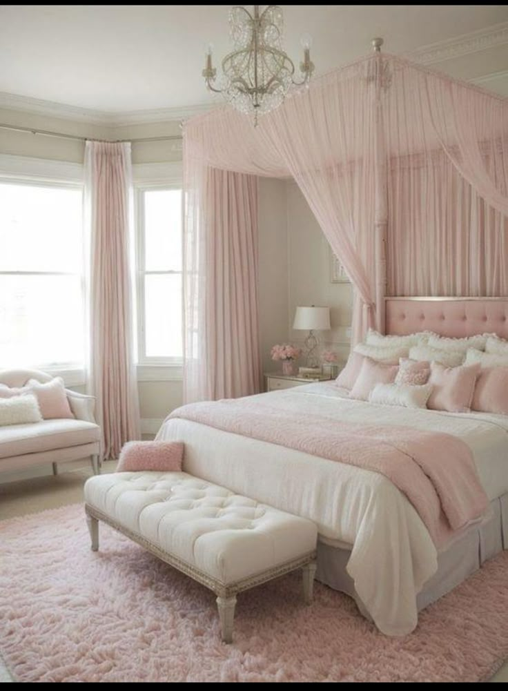 a bedroom with pink and white decor in the corner, chandelier above the bed