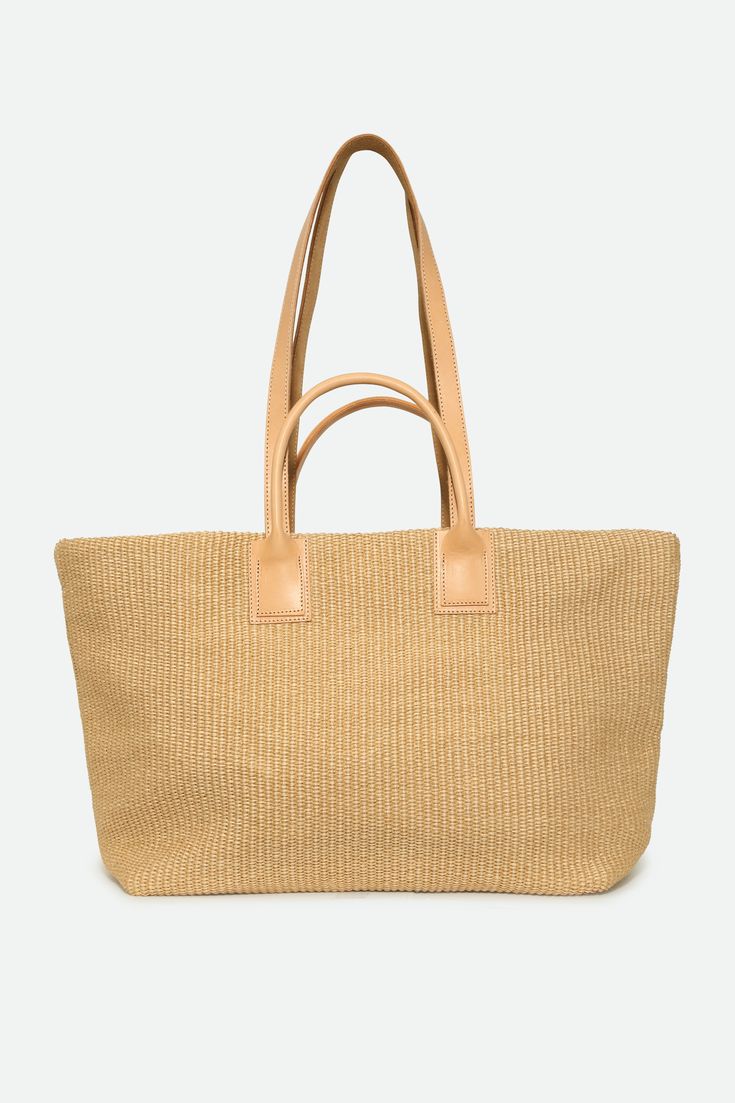 Experience the luxury of Italian craftsmanship with the exquisite Lisbon tote. Meticulously hand-sewn from straw and premium Italian leather. Yellow weave and natural tan leather contrast, this tote exudes timeless refinement and summer festivities. Size At base 15" length X 7" width 13" height 23" at tote opening 13.5" Large strap clearance 5" Short handle clearance 8" X 10" Inner zip pocket Details and Care Color: Yellow with light natural tan leather contrast Made by hand in Asolo, Italy Spot Luxury Bag With Rolled Handles In Natural Color, Luxury Straw Tote Bag With Rolled Handles, Luxury Natural Straw Bag For Shopping, Luxury Natural Shoulder Bag With Rolled Handles, Luxury Beige Tote Beach Bag, Luxury Natural Straw Bag For Vacation, Neutral Straw Tote Bag For Shopping, Neutral Straw Bag With Braided Handles For Shopping, Elegant Beige Beach Bag With Leather Handles