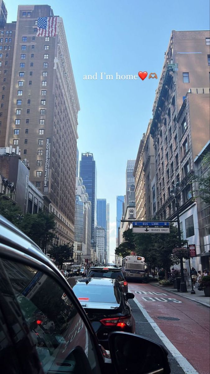 cars are parked on the street in front of tall buildings