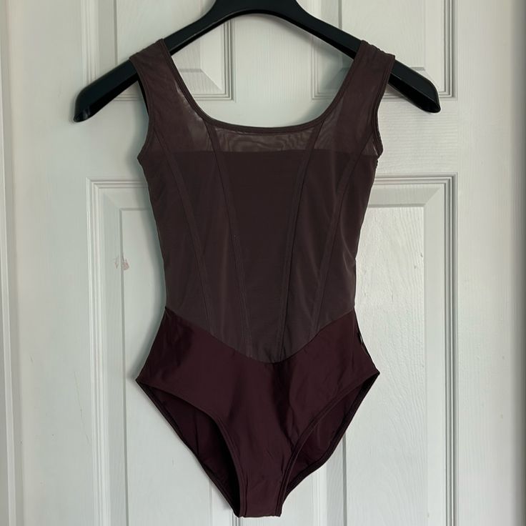 a woman's bodysuit hanging on a door