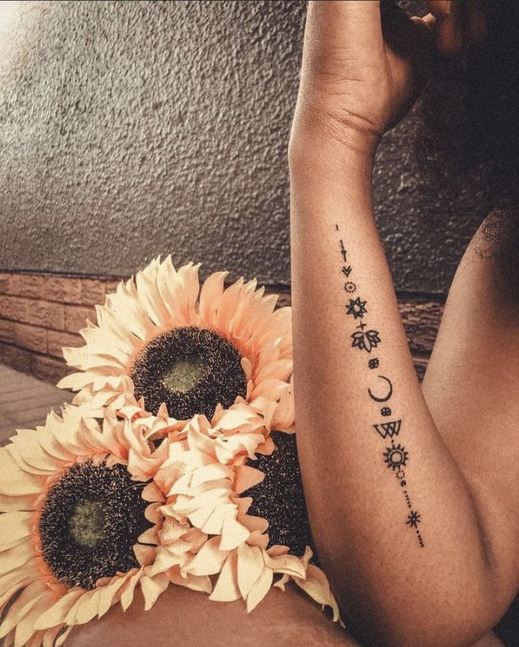 a woman with sunflowers on her arm and the words i love you written in cursive writing