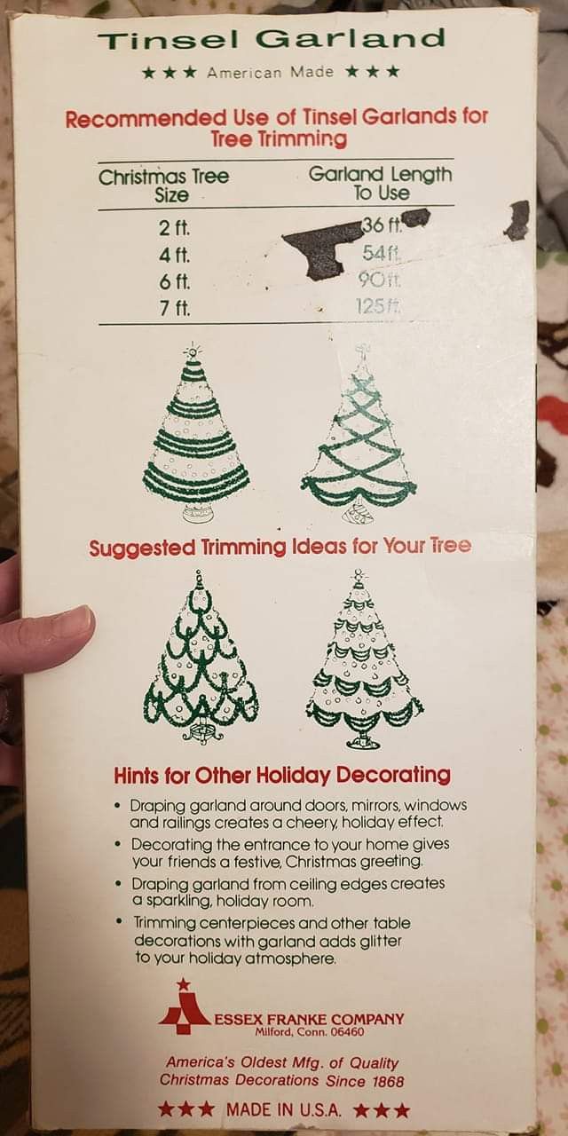 someone is holding up a christmas tree card