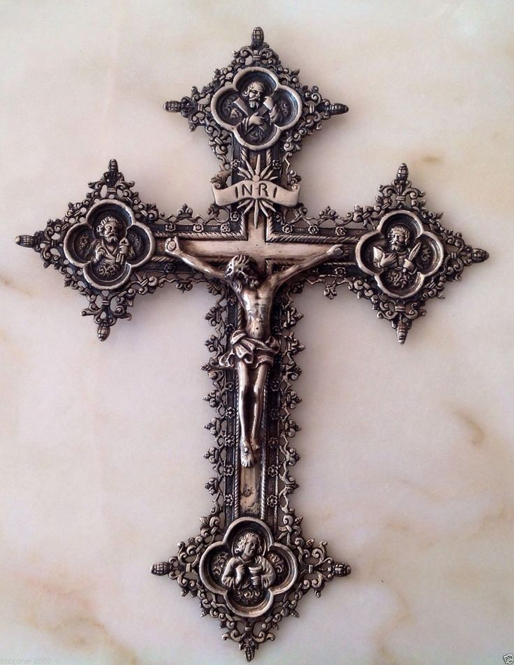 an ornate cross on a marble surface