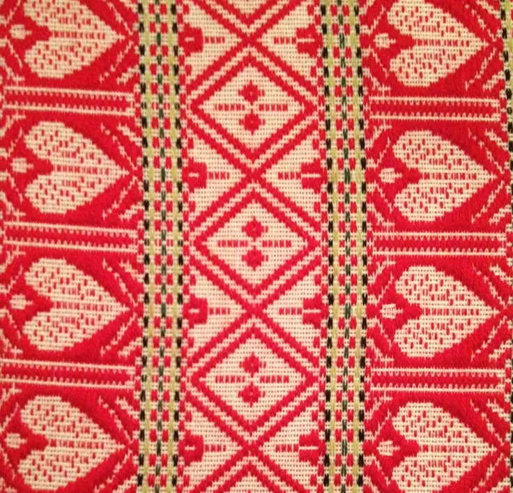 red and white woven fabric with hearts on the side, in different patterns or colors