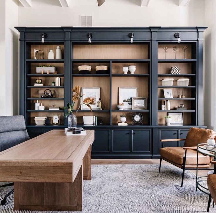 a living room filled with furniture and lots of shelves