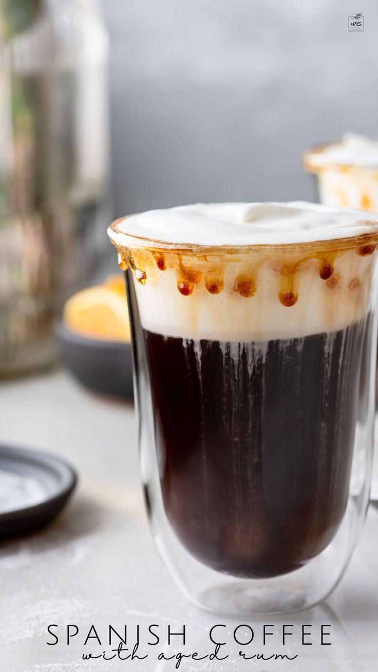 two cups filled with liquid sitting on top of a table