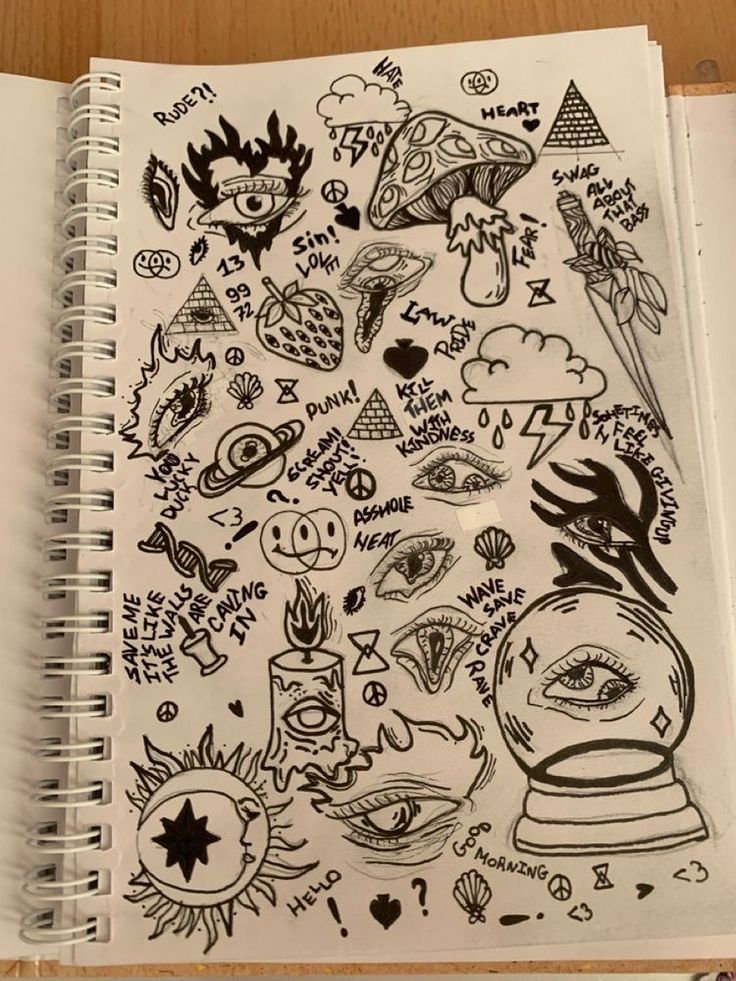 an open notebook with drawings on it