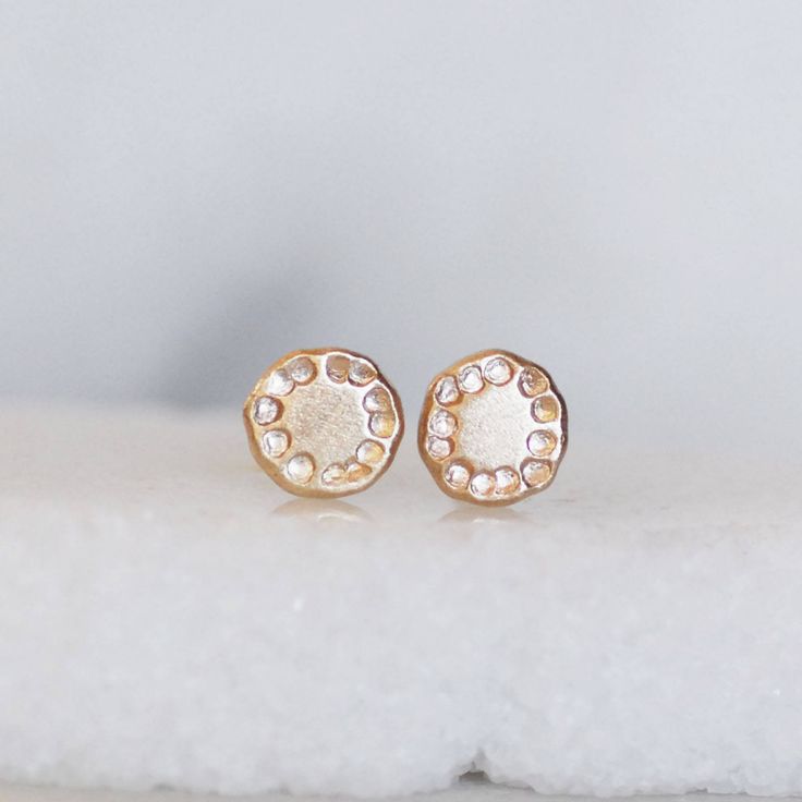 14k yellow gold Wildflower earrings on your choice of either 14k gold posts OR Sterling Silver posts. Handmade rounded gold discs hammered with a pattern reminiscent of a wildflower. Classic and modern, these are a little bit of luxury you can wear every day. Earrings are about 5.5-6mm's in diameter Posts ad ear backs - Choose between 14k gold or Sterling silver ear backs (the flower on both is 14k gold) Gold and Silver - Eco Friendly, Recycled Finish - Pictured with brushed finish, but can also 14k Yellow Gold Round Cluster Earrings, Gold 14k Diamond Earrings Gift, Delicate 14k Gold Round Earrings, Delicate Gold Cluster Earrings For Anniversary, Gold Diamond Earrings Stamped 14k For Wedding, Everyday 14k Stamped Yellow Gold Earrings, Delicate Gold Diamond Earrings For Everyday, Dainty Gold Round Diamond Earrings, Dainty Gold Cluster Earrings For Anniversary