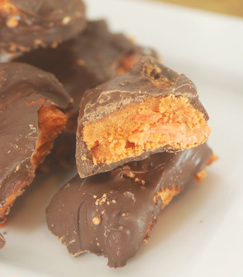 pieces of chocolate and peanut butter on a white plate