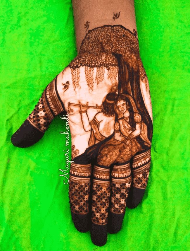 the hand is decorated with henna and tattoos on it's palm, which shows an image of two women