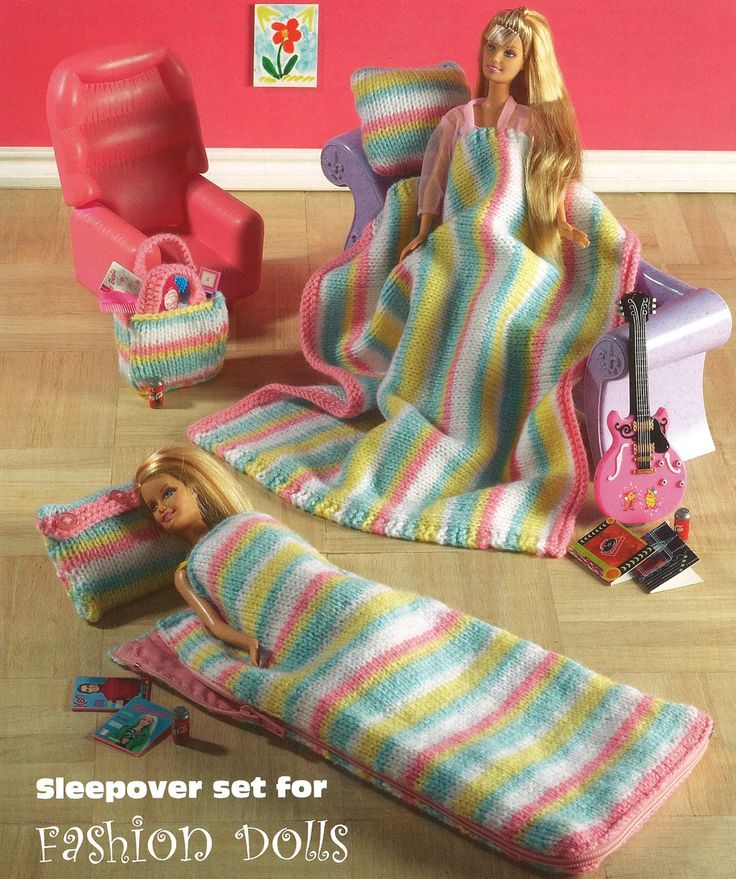 there is a barbie doll laying on the floor next to a blanket and other items