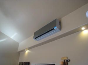 an air conditioner mounted to the ceiling in a living room