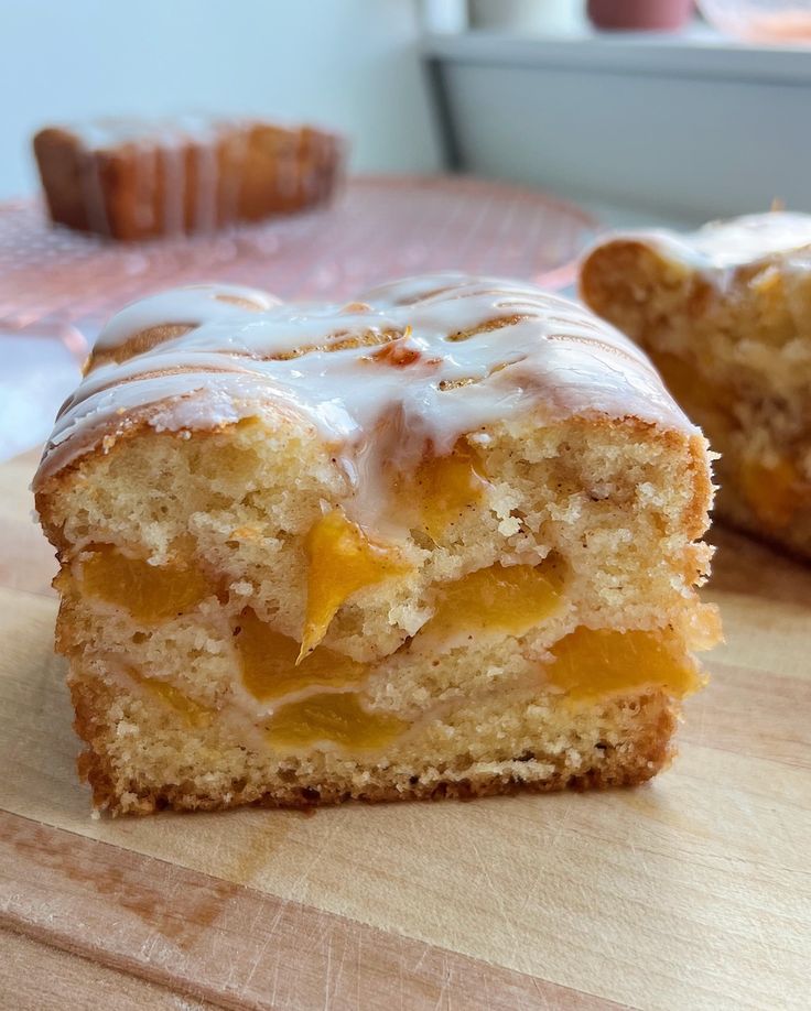 two pieces of cake sitting on top of a wooden cutting board