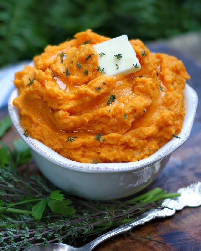 a white bowl filled with mashed sweet potatoes