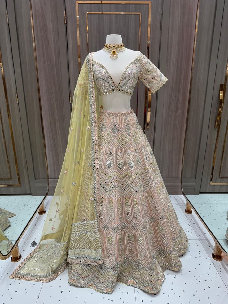 Be the daring bride and steal the show with our Bridal Lehenga BL-283! In a stunning peach color with intricate mirror work, this lehenga is perfect for your sangeet night. Make a statement and embrace your adventurous side with this bold and beautiful piece! Fabric: Organza! WASH CARE INSTRUCTIONS - Please Dry clean only when it is applicable! Ready to Ship! Elegant Peach Lehenga With Dupatta, Elegant Semi-stitched Peach Lehenga, Fitted Peach Traditional Wear With Zari Work, Elegant Semi-stitched Peach Choli, Elegant Peach Choli For Reception, Elegant Peach Lehenga With Zari Work, Elegant Peach Designer Wear Lehenga, Elegant Designer Peach Lehenga, Designer Peach Lehenga With Intricate Embroidery