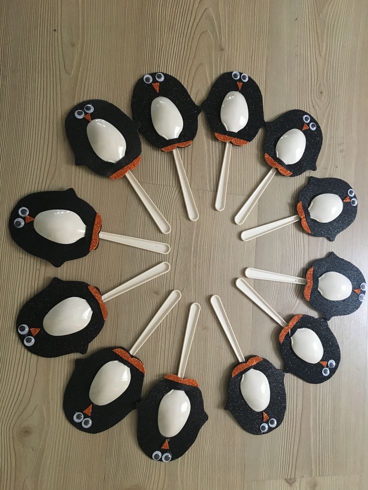 a group of penguin cupcakes sitting on top of a wooden table