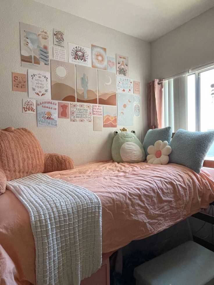 a bedroom with a bed, window and pictures on the wall