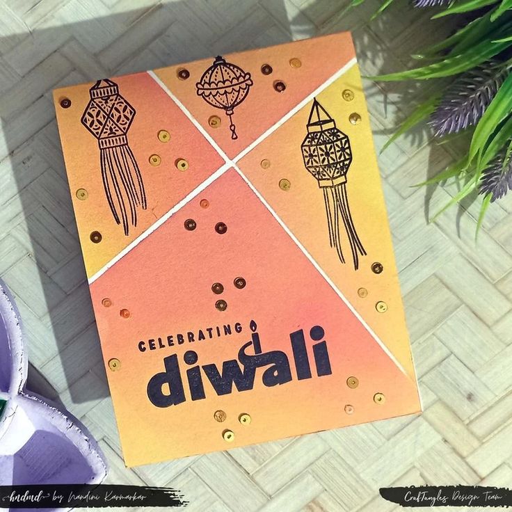 an orange and yellow card with the words celebrating diwali on it next to some shoes