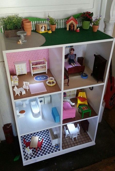 a doll house with lots of furniture and toys in it's display case on the floor