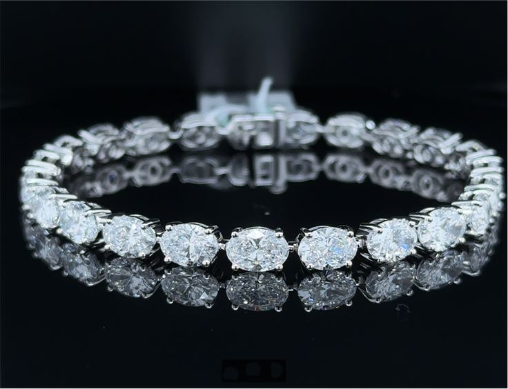 B16DO14KW New Oval Lab Diamond Tennis Bracelet, 16.61 Carats on 14k White Gold - Certificate of Authenticity - Bracelet Material: 14k White Gold - Gold Finish: Polished - Lab Diamond Count: 23 - Total Diamond Weight: 16.61 Carats (0.722 Carats per Stone) - Diamond Clarity: VS1 - Diamond Color: E - Diamond Shape: Oval Gold Certificate, Vs1 Diamond, Diamond Tennis Bracelet, Authentic Watches, Tennis Bracelet Diamond, Diamond Color, Diamond Shape, Oval Diamond, Tennis Bracelet