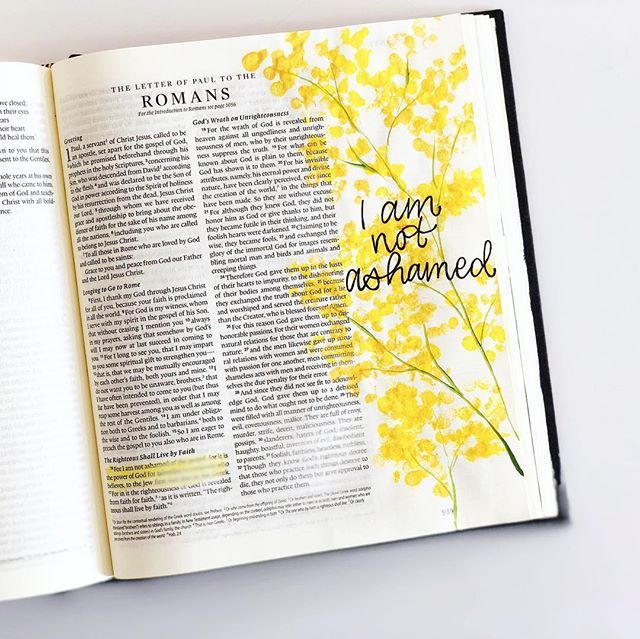 an open bible with yellow flowers and the words i am not transformed written on it