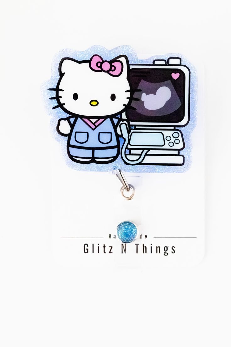 a hello kitty charm with a laptop on it's back end and a keychain hanging from the front