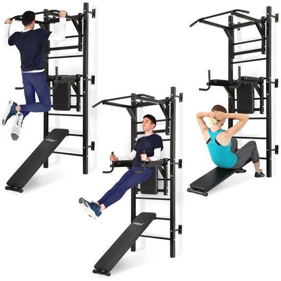 a man and woman doing squats on pull ups in front of a gym machine