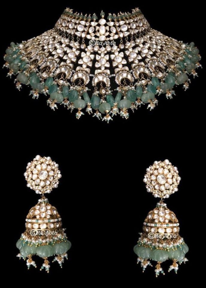 Open polki necklace set with russian emerald melons, green stone hangings, medium sized jhumkas, green nath and mint gre en mathapatti. Green Bridal Necklace With 17 Jewels For Ceremonial Occasion, Green Tilla Jhumkas For Reception, Heavy Green Kundan Necklace For Ceremonial, Green Hand Set Jhumkas For Festivals, Ceremonial Heavy Green Kundan Necklace, Green Jhumkas For Reception And Festivals, Green Emerald Chandbali Necklace For Festivals, Green Kundan Necklace With 17 Jewels, Festival Green Emerald Chandbali Necklace