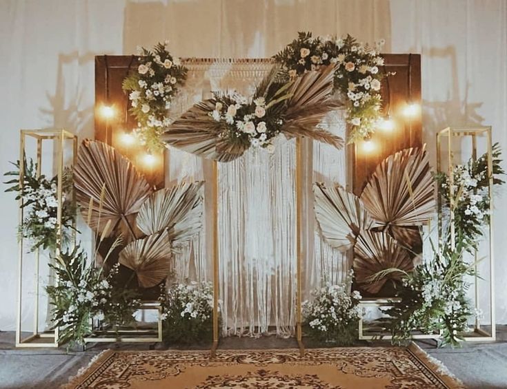 a decorated stage with flowers and greenery