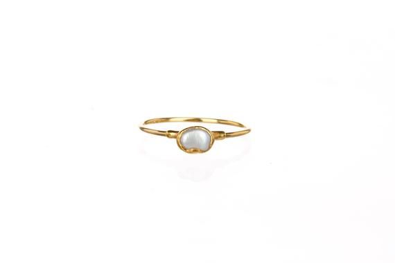 A delicate white pearl ring. As shown in the first photo, these make excellent stacking rings. ✨Gem size 4-5mmWhite Fresh Water PearlPure 14k gold fill Shank24k Gold Dipped✨Please read our FAQ for more information on our unique materials and process. You will receive one of the pieces pictured above, or a piece nearly identical to the rings above. Since each gemstone is one-of-a-kind, I cannot guarantee that the gemstone you see above will still be available. I have tried my best to photograph t Delicate Gold Opal Ring, Dainty Gold Moonstone Ring For Everyday, Delicate White Moonstone Ring In 14k Gold, Delicate Round Pearl Ring For Everyday, Delicate Everyday Round Pearl Ring, Elegant Tiny Moonstone Promise Ring, Gold Minimalist Oval Pearl Ring, Minimalist Gold Moonstone Ring For Everyday, Minimalist Gold Oval Pearl Ring