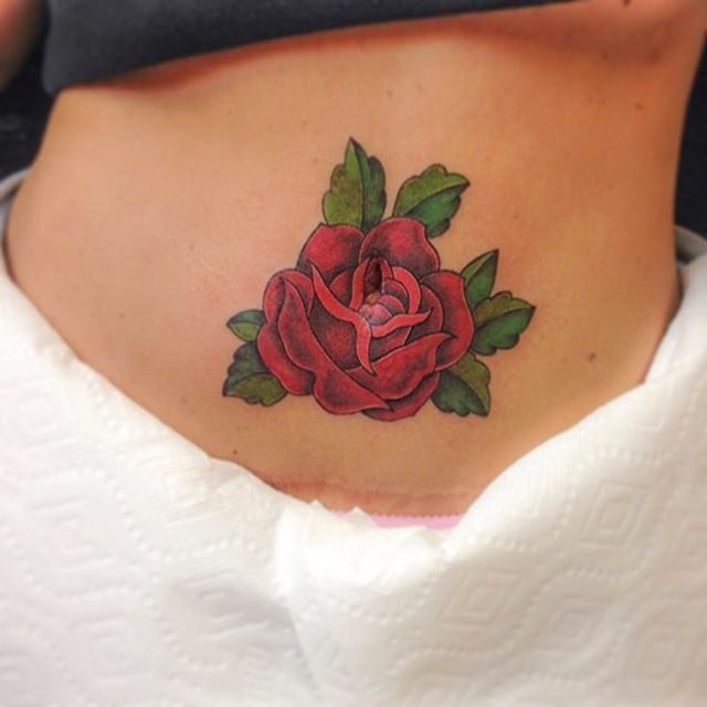 a woman with a rose tattoo on her stomach