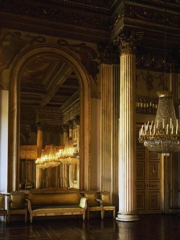 an ornately decorated room with columns and chandelier