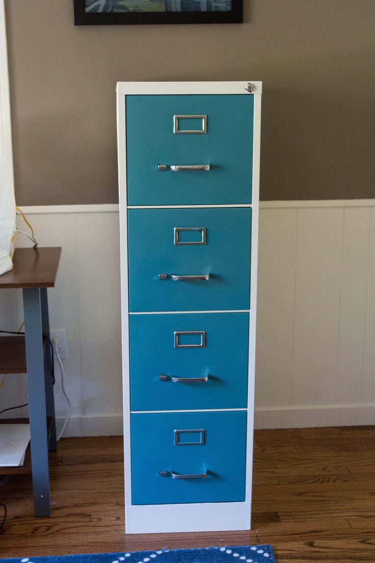 a blue and white filing cabinet sitting on top of a hard wood floor