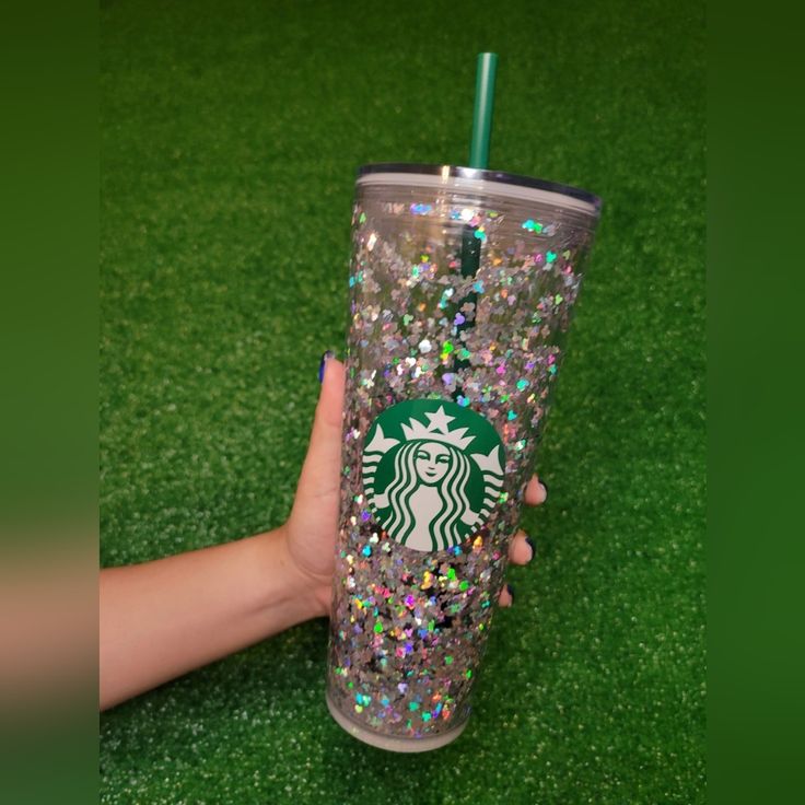 a hand holding a starbucks cup filled with glitter