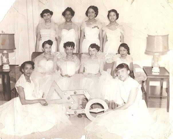 a group of women in white dresses posing for a photo with the number 4 on it