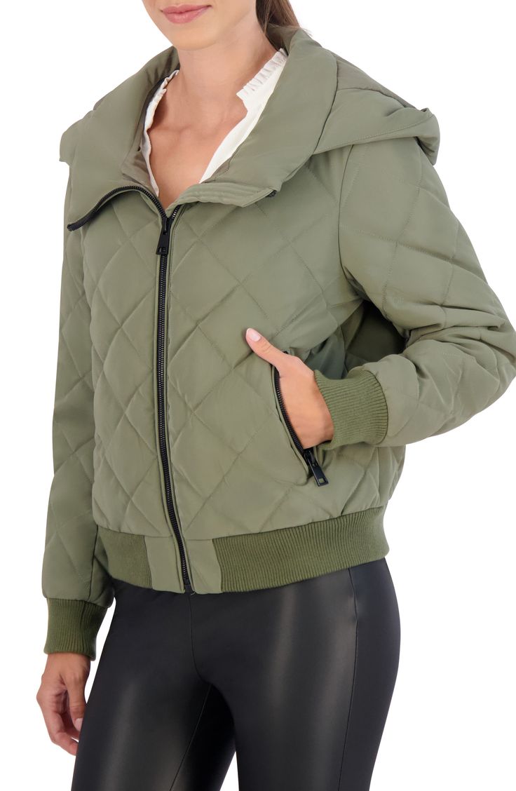 Stay warm in this water-resistant quilted bomber jacket constructed with an attached hood, secure zip pockets and comfortable ribbed trim. Front zip closure Fixed hood Front zip pockets Lined, with synthetic fill 100% polyurethane with 100% polyester backing Machine wash, line dry Imported Model stats: 5'10" height, 32" bust, 25" waist, 36" hip. Model is wearing size Small. Sporty Puffer Jacket For Cold Weather, Trendy Outdoor Hooded Jacket With Detachable Hood, Fall Quilted Jacket With Detachable Hood For Outdoor, Hooded Puffer Jacket With Detachable Hood For Cold Weather, Quilted Jacket For Cold Weather, Solid Quilted Jacket For Cold Weather, Sporty Puffer Hooded Jacket For Fall, Sporty Hooded Outerwear With Zipper Closure, Hooded Quilted Puffer Jacket For Outdoor Activities