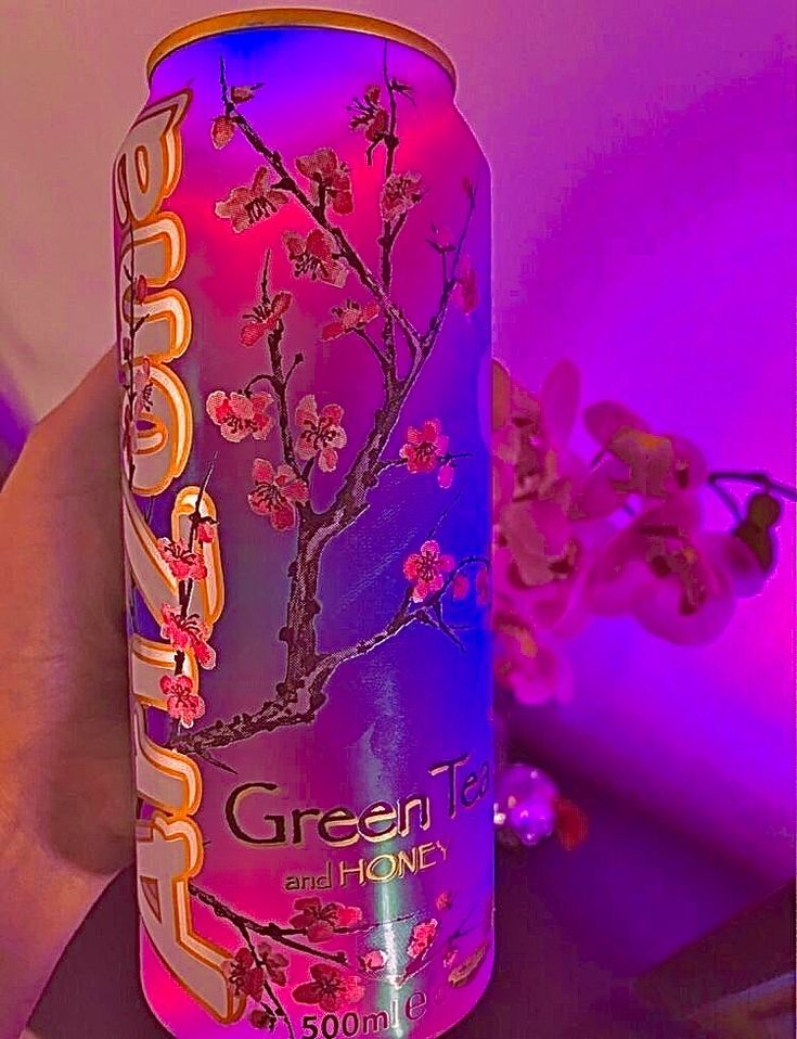 a pink and purple can with flowers on it