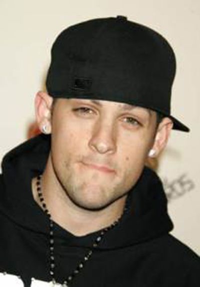 a man wearing a black hat and hoodie