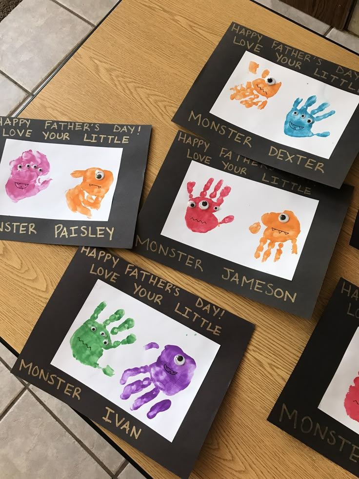 four handprints are displayed on the table for children to write their names and pictures