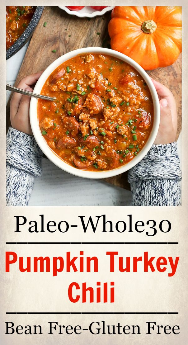 a person holding a bowl of pumpkin turkey chili with the title paleo - wholego pumpkin turkey chili