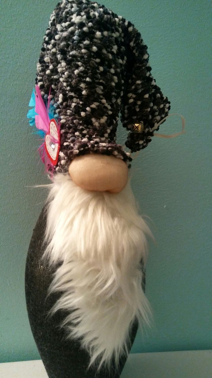 a black and white stuffed animal with a hat on top of it's head