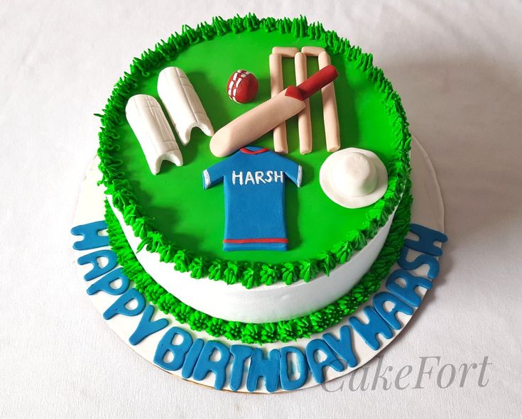 a cake decorated with green frosting and sports items