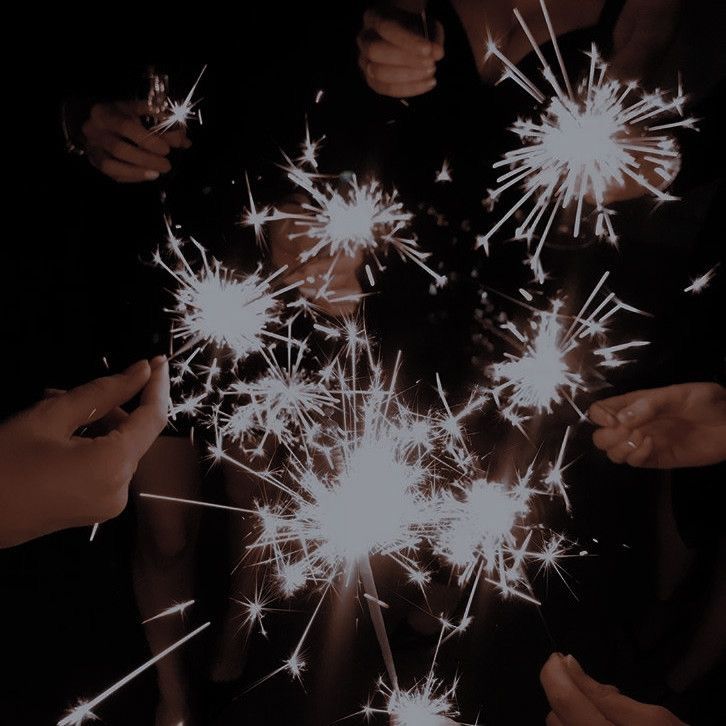 several people are holding sparklers in their hands