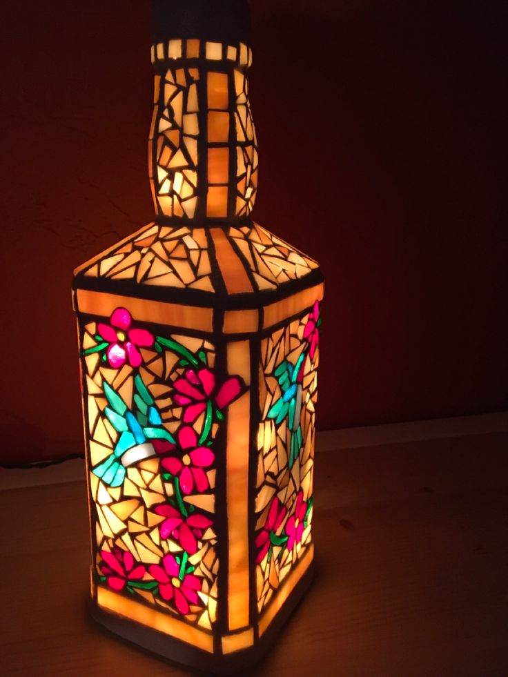 a lamp that is lit up with colorful lights on the top and bottom of it