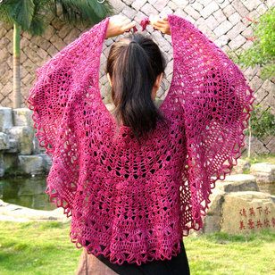 a woman wearing a pink crocheted shawl