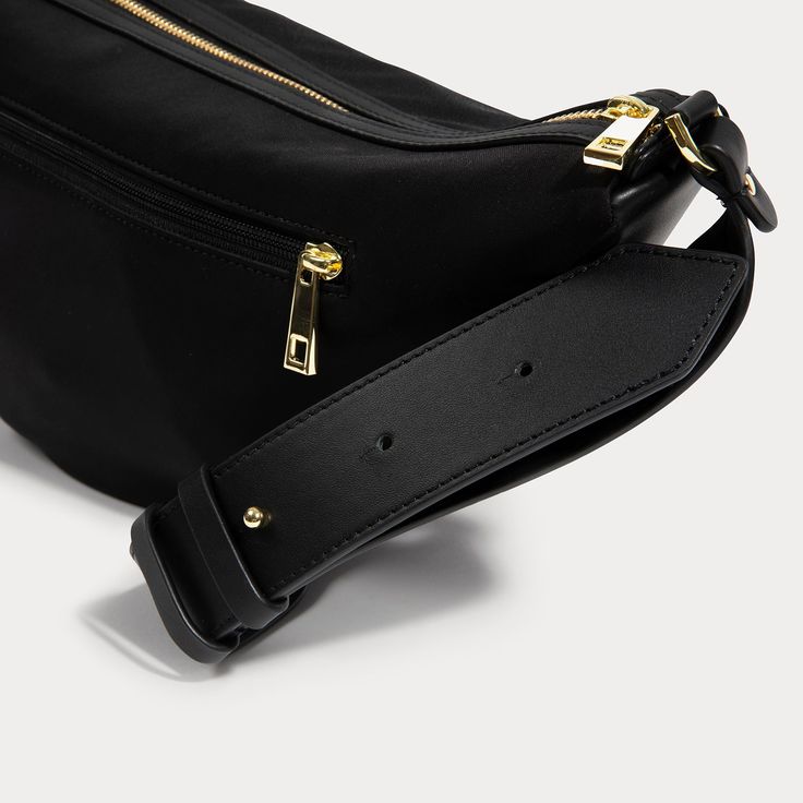 Balancing style and practicality is no easy feat. Meet the Daphne Half Moon Bag, where chic design meets ultimate functionality. Thoughtfully designed with an adjustable leather strap, nylon bag material, both exterior and interior pockets, and premium gold hardware. Luxury Belt Bag With Zipper Pocket, Black Rectangular Belt Bag With Gold-tone Hardware, Luxury Nylon Business Bags, Luxury Business Nylon Bags, Luxury Everyday Belt Bag With Zipper Pocket, Luxury Rectangular Belt Bag With Zipper Pocket, Luxury Belt Bag With Gold-tone Hardware For Daily Use, Functional Evening Shoulder Bag With Zipper Closure, Elegant Belt Bag With Adjustable Strap For Travel